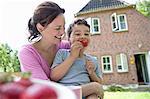 Mother and son eating outdoors