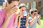 Mother and children drinking outdoors