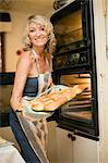 Smiling woman baking in kitchen