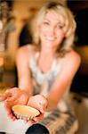 Smiling woman making tarts in kitchen