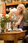 Woman arranging table in kitchen