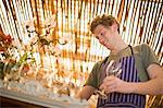 Man arranging wine glasses in kitchen