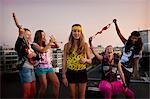 Teenage girls playing music on roof