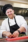 Smiling chef at work in kitchen