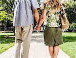 Older couple holding hands in park