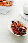 Bowl of roasted vegetables on table