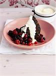 Chocolate cake with berries and cream