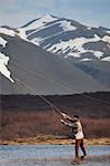 Man fishing in still lake