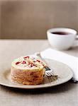 Plate of fruit swiss roll with coffee