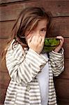 Girl eating watermelon outdoors