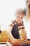 Boy playing with abacus indoors