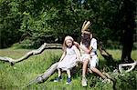 Girls in costumes in tree outdoors