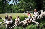 Children in costumes playing on tree