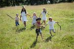 Children in costumes running in field