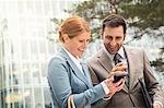 Business people using cell phone