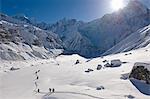 Hikers in snowy mountain landscape