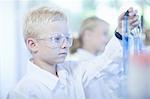 Boy playing scientist in lab