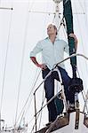 Man standing on deck of yacht
