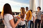 Group of friends at house party on balcony