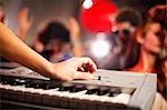 Young woman playing keyboard in nightclub