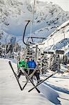 Couple riding ski lift, Warth, Vorarlberg, Austria
