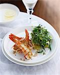 Plate of prawn salad with potatoes and micro herbs