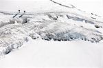 Mountaineers traversing deep snow, high angle