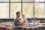 Young couple using cell phone in grocery store market