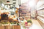 Fresh produce in shopping cart in grocery store market