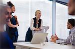 Business people discussing paperwork in conference room meeting