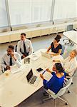 Business people working, listening in conference room meeting