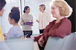 Businesswomen talking in conference audience