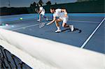 Young male tennis doubles players playing tennis on tennis court