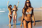 Three beautiful girls having fun on the beach