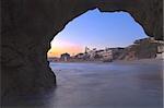 Keyhole cave at Pearl Street Beach in Laguna Beach at sunset with the water blurred to a glassy look.