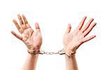 Male hands on a white background close-up in metal handcuffs