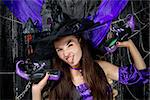 horizontal portrait of a cheerful witch with shoes in hands on a black background