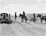 1930s TWO NAVAJO MEN WITH PONIES STOP TO SPEAK TO PARK RANGER WITH TWO WOMEN TOURISTS
