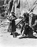 1930s TWO NATIVE AMERICAN NAVAJO INDIAN WOMEN GRINDING CORN AND HARVESTING SQUASH CANYON DEL MUERTO ARIZONA USA