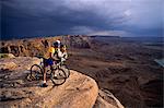 1990s COUPLE WITH BIKES AMASA BACK TRAIL MOAB UTAH USA