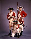 1970s 1776 AMERICAN REVOLUTION HISTORICAL REENACTORS WEARING BRITISH RED COATS OFFICER AND TWO SOLDIERS WITH FLINTLOCK MUSKETS