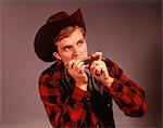 1960s MAN PLAYING HARMONICA WEARING COWBOY HAT COUNTRY WESTERN PERFORMER ENTERTAINER