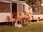 1960s FAMILY VACATION RV POP-UP CAMPER MOTHER THREE CHILDREN ALL GIRLS FATHER SITTING PLAYING GUITAR