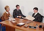 1960s COUPLE BEING INTERVIEWED BY BANK LOAN OFFICER