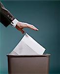 1960s MALE HAND THROWING OUT LETTER INTO TRASH CAN