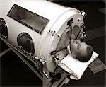 1930s 1940s 1950s MAN LYING IN IRON LUNG NEGATIVE PRESSURE VENTILATOR ARTIFICIAL BREATHING MACHINE