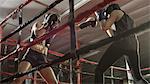 Low angle view of female boxers punching and fighting in boxing ring during match