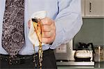 Businessman crushing coffee cup