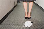 Businesswoman stood in front of pile of paper shreddings