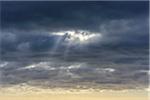 Sun breaking through storm clouds at Bamburgh in Northumberland, England, United Kingdom